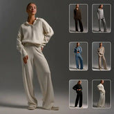 Woman wearing a cream-colored oversized sweater and wide-leg pants from a fall winter two piece set